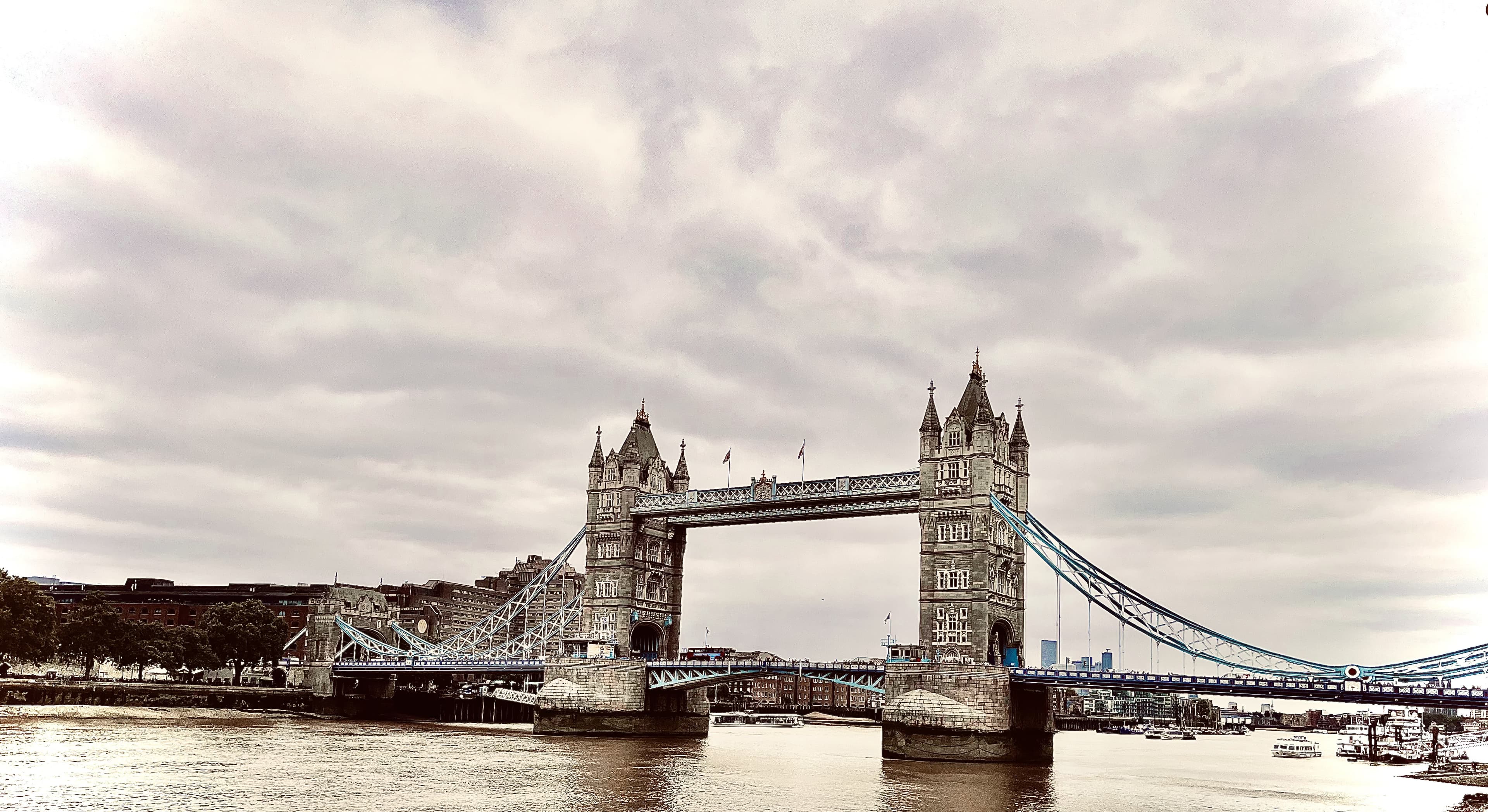 Tower Bridge spanning the River Thames under a cloudy sky, London
